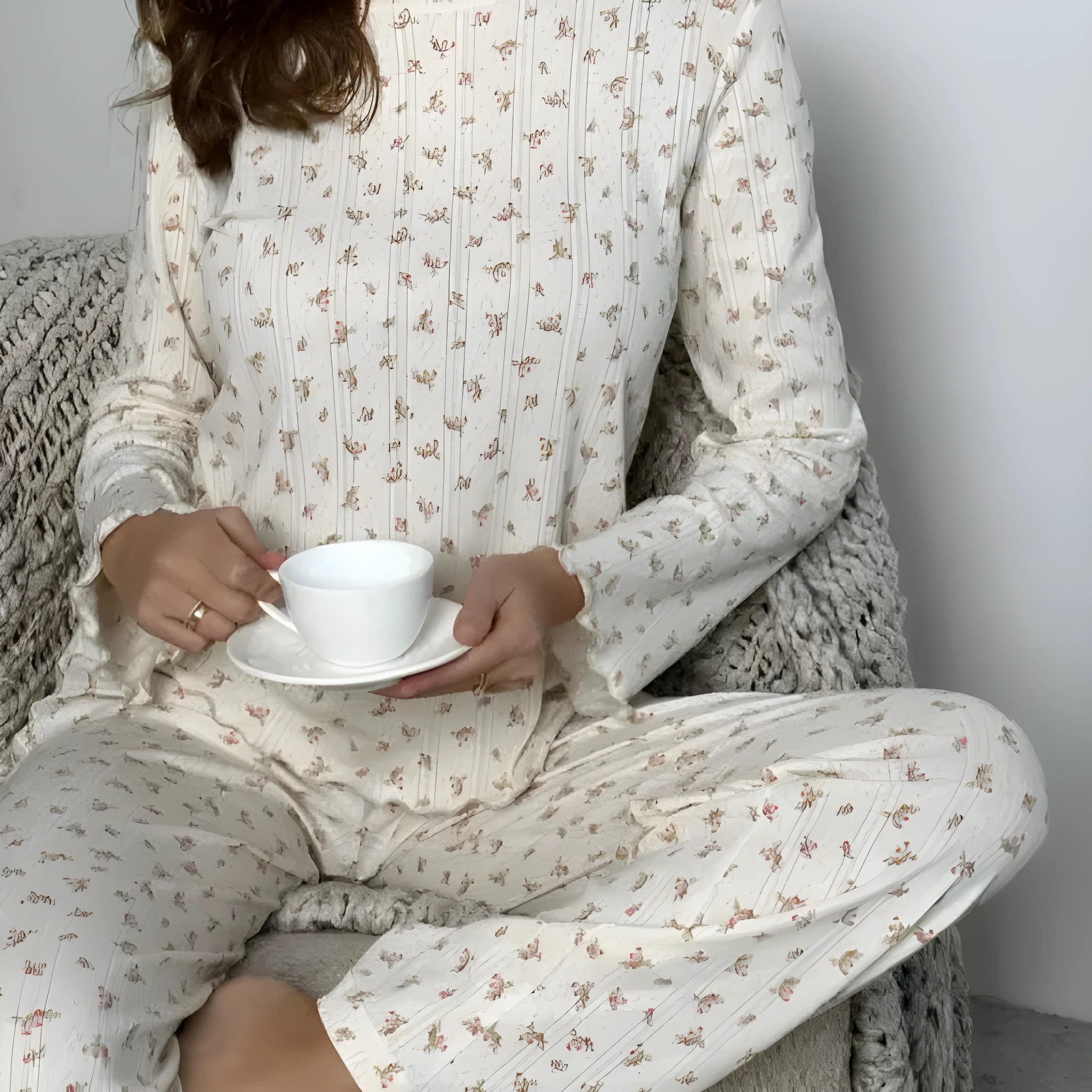 White floral print women's sleepwear set with long bell sleeve top and wide-leg trousers.