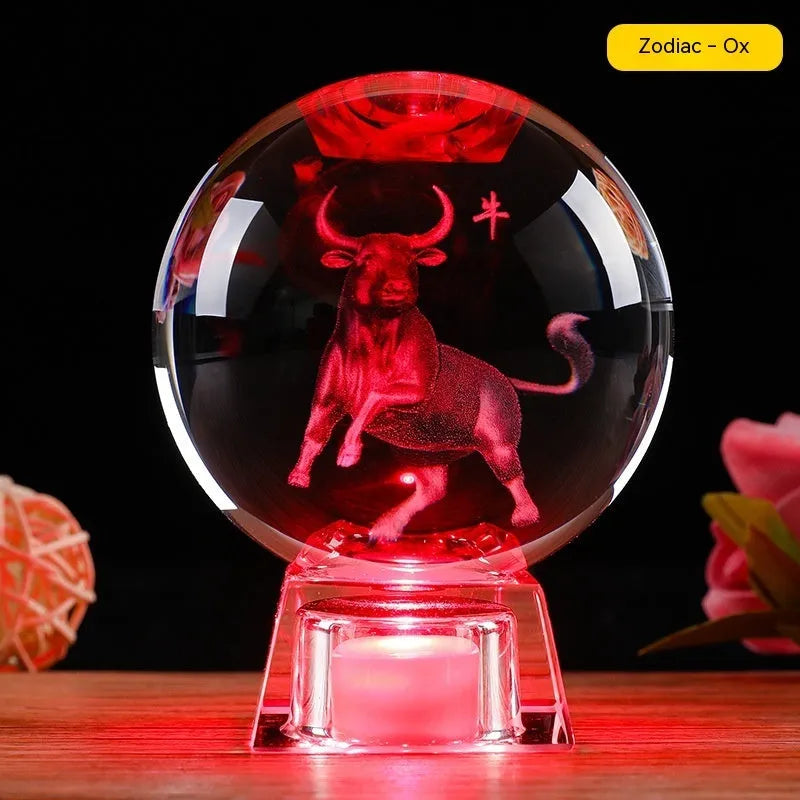 White luminous crystal ball ornament with Chinese zodiac animal figure on electronic base.