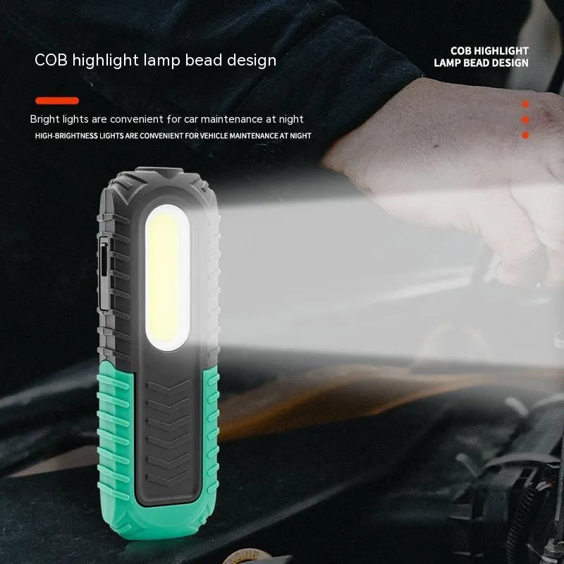 Black and green auto repair work light with USB charging cable and PET-coated ABS construction