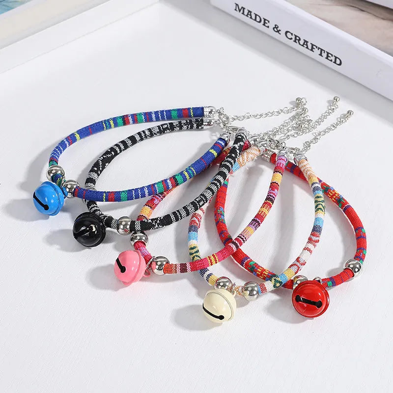 Colourful ethnic style adjustable dog collar with a bell, shown in multiple colour options.