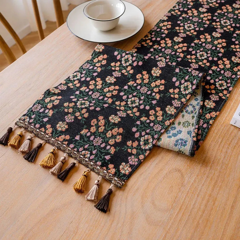 Dark blue Nordic Jacquard bouquet pattern table runner with tassel trim, 32cm wide.