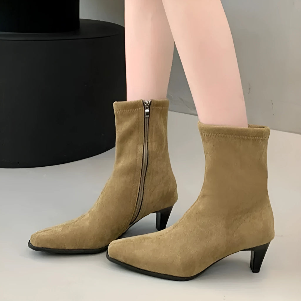 Brown women's square toe ankle boots with a side zip and a mid-height stiletto heel.