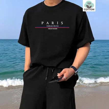Man wearing a heavy grey pure cotton T-shirt with a printed letter design and short sleeves.