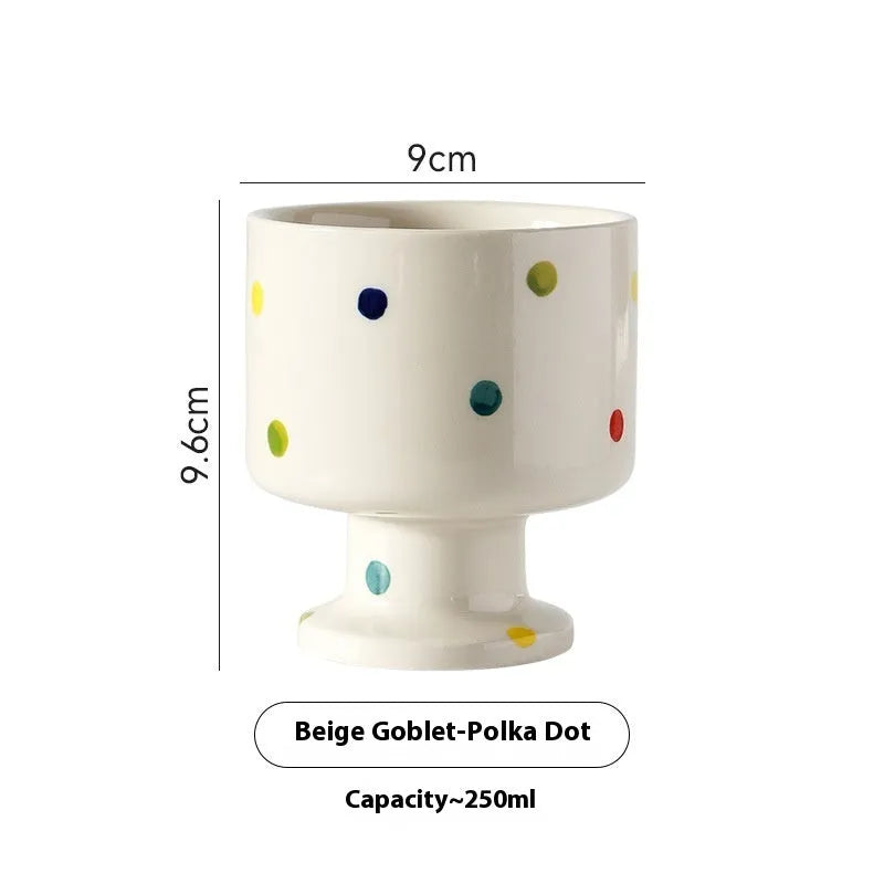 A handmade, irregularly shaped ceramic mug in a solid colour, shown on a table.
