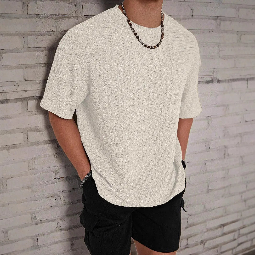 Men's slim fit loose hollow polyester t-shirt in black, shown on a model.