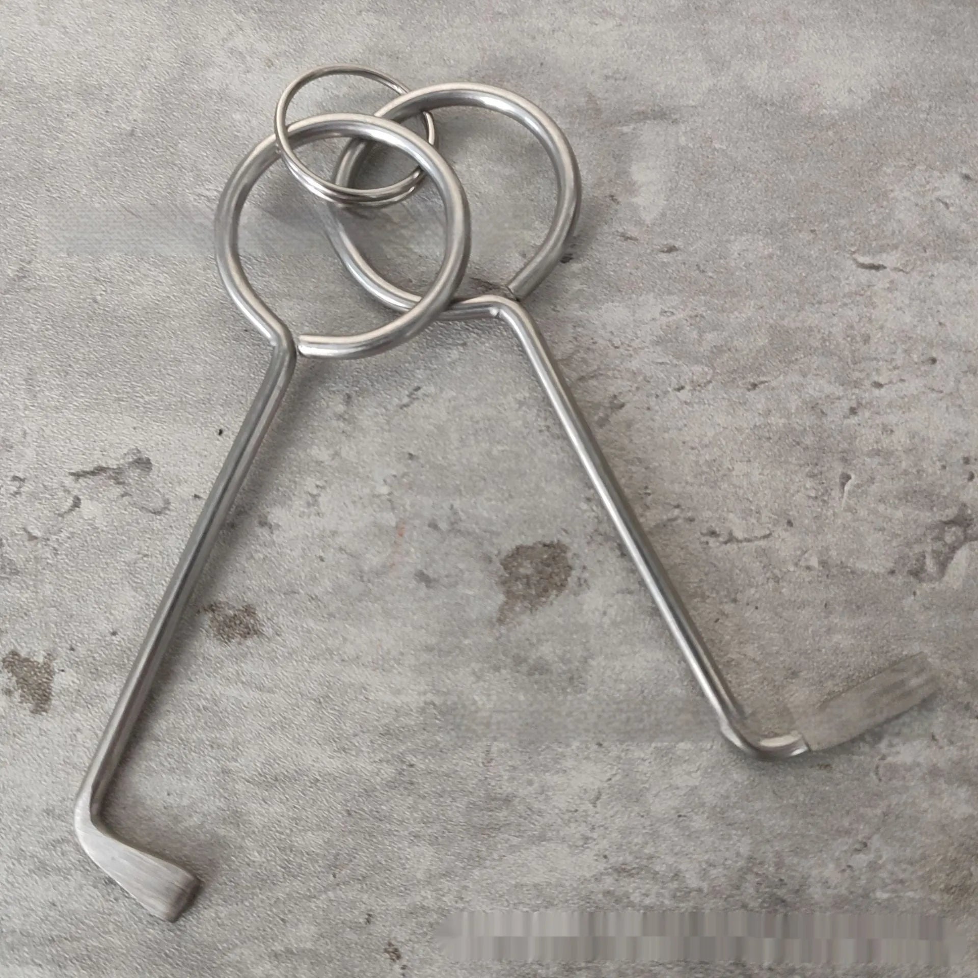 Two silver alloy wrench tools from a portable universal tool set.