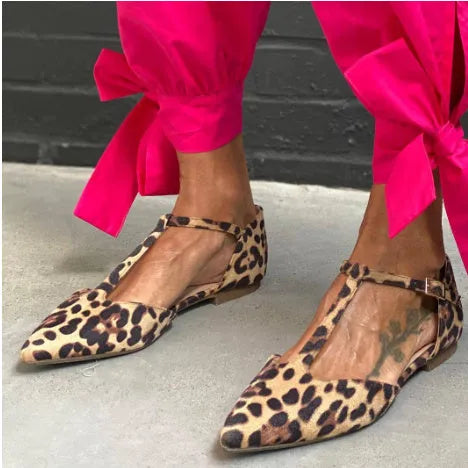 Leopard print women's pumps with a pointed toe, cross straps, and a chunky low heel.