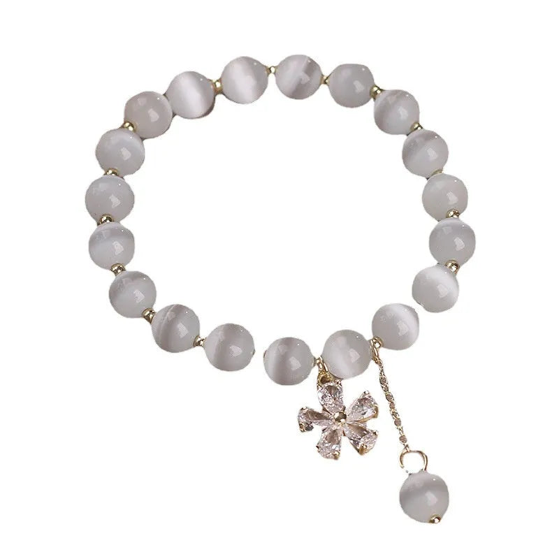 Women's white cat's eye stone bracelet with flower tassel pendant and safety buckle clasp