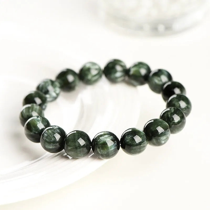 A single-ring green dragon crystal bracelet with round beads and a ruyi design element.
