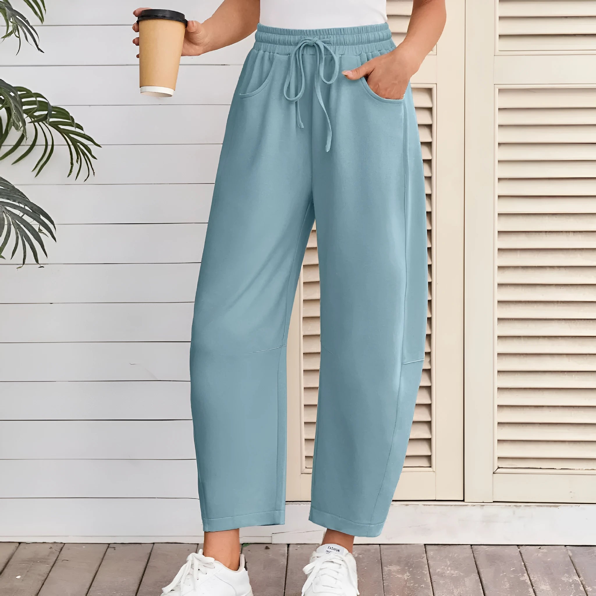 Women's loose cropped sweatpants with drawstring waist and side pockets in apricot colour