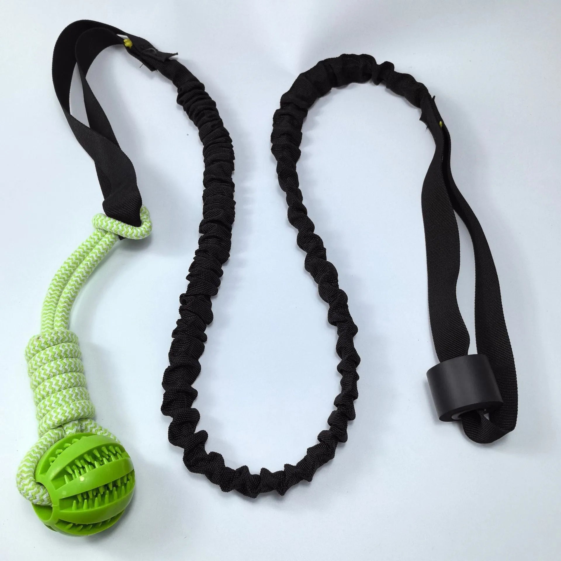 Green cotton rope dog toy with ball for tug of war and fetch games.