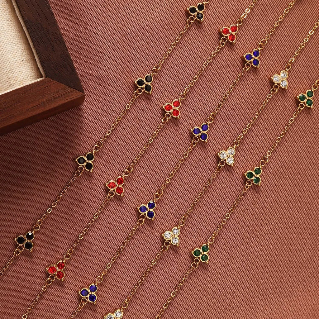 Women's geometric stainless steel bracelet with triple diamond design and coloured stone in gold or steel tone.