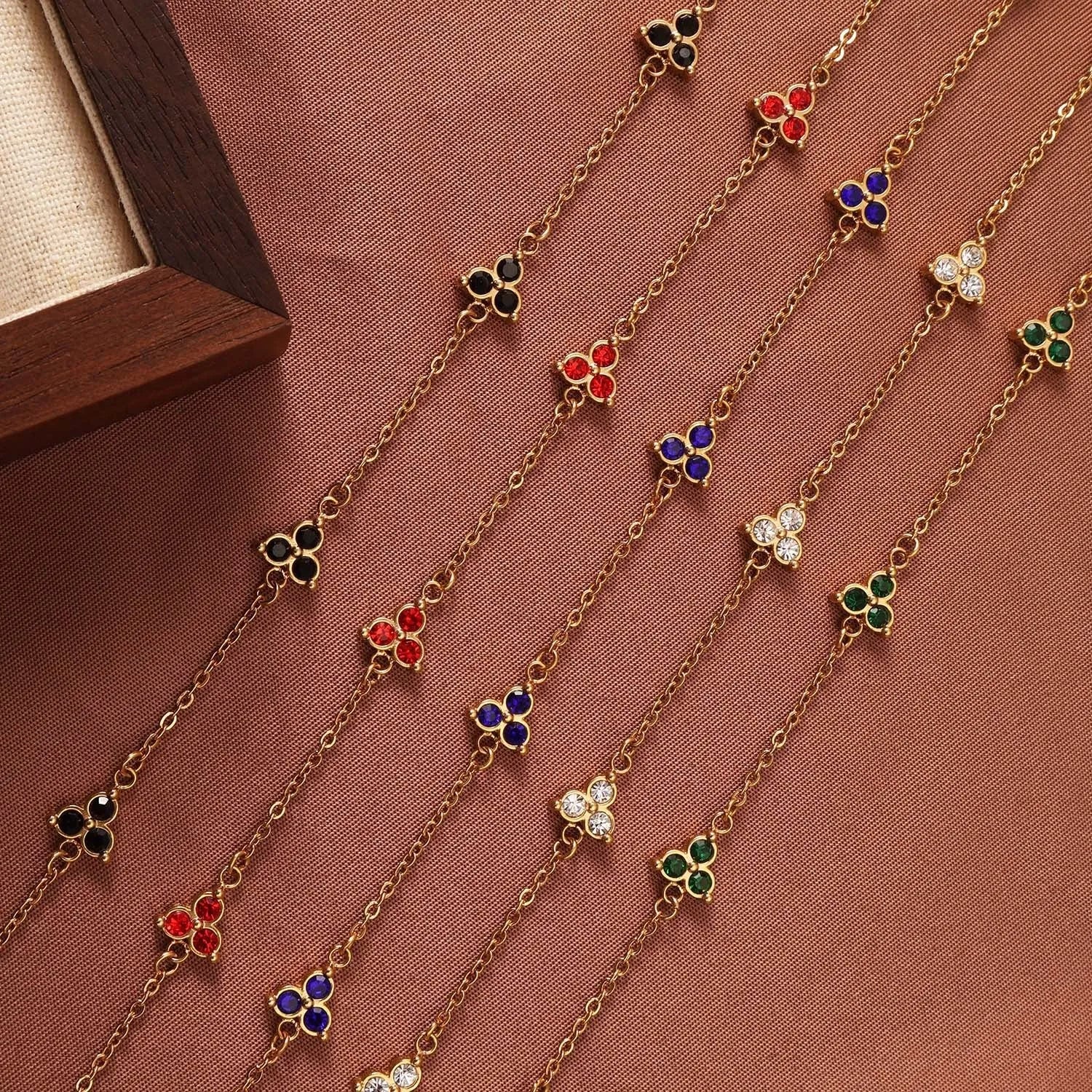 Women's geometric stainless steel bracelet with triple diamond design and coloured stone in gold or steel tone.