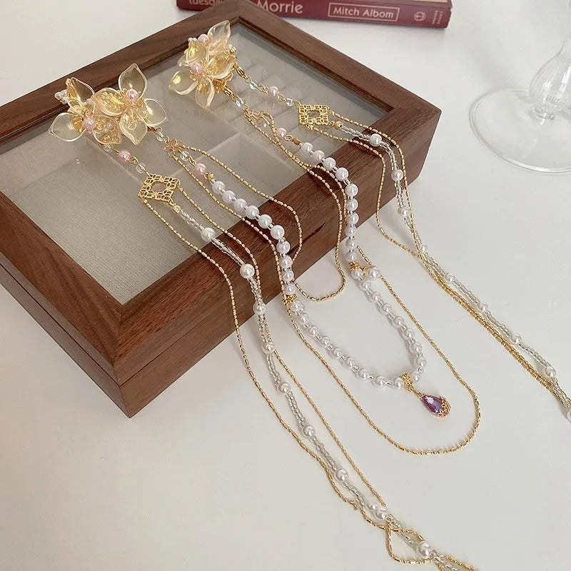 Gold women's hairpin with pearl, diamond flower and long tassel design