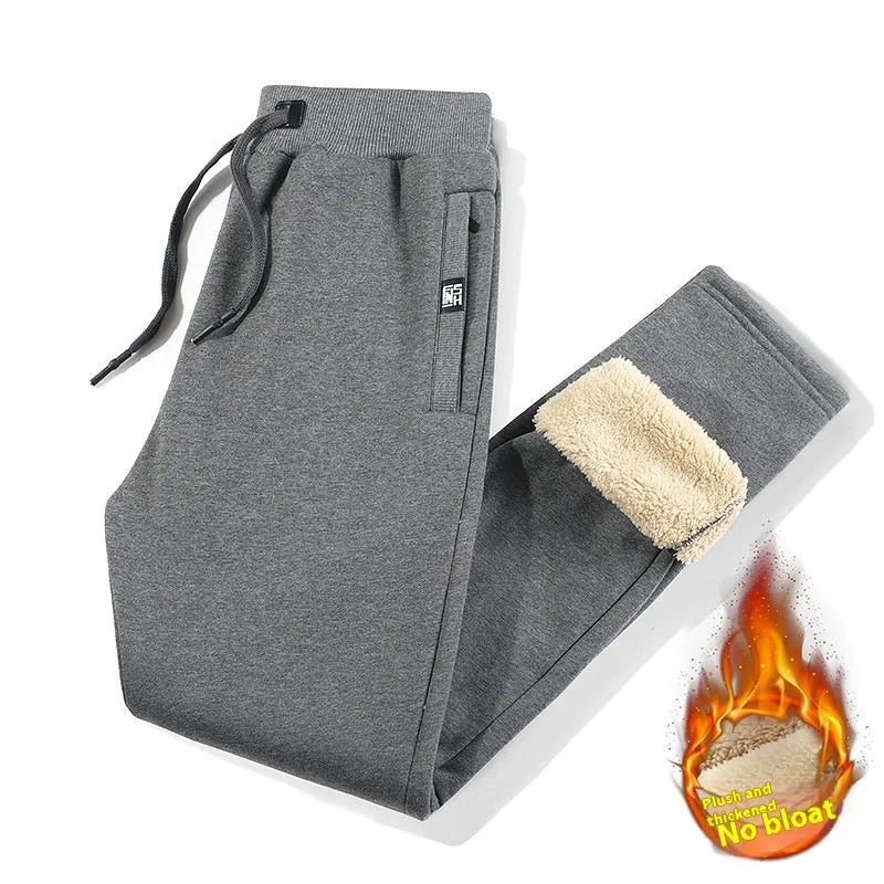 Men's grey fleece-lined cotton track pants in oversized style showing drawstring leg detail