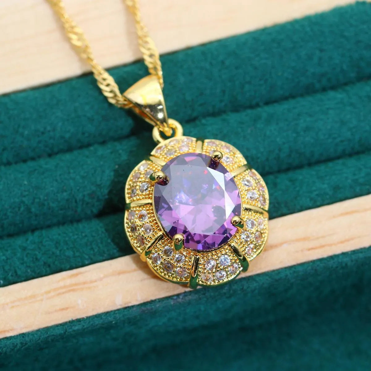 18k gold plated jewellery set with coloured cubic zirconia stones showing necklace, earrings, ring, and bracelet