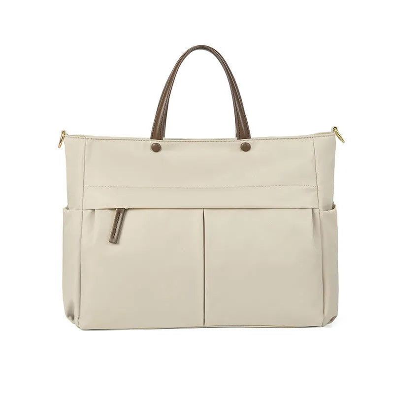 Women's Oxford cloth briefcase with shoulder strap showing open pocket organisation and contrast stitching details
