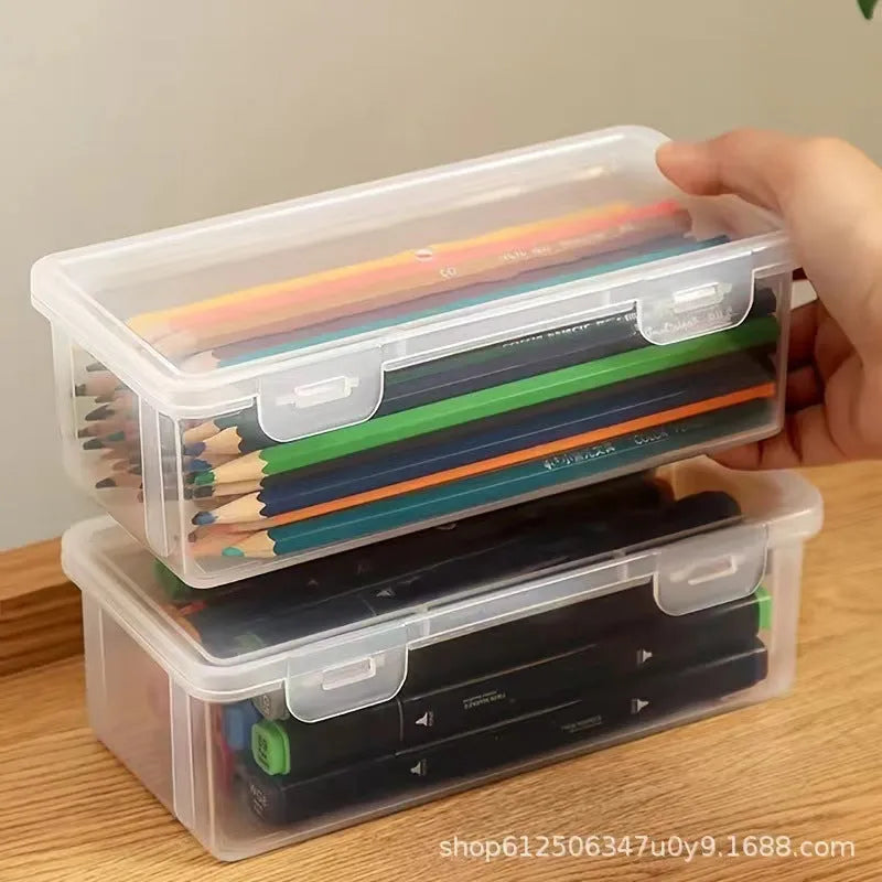 Transparent plastic stationery storage box containing pencils and coloured art supplies