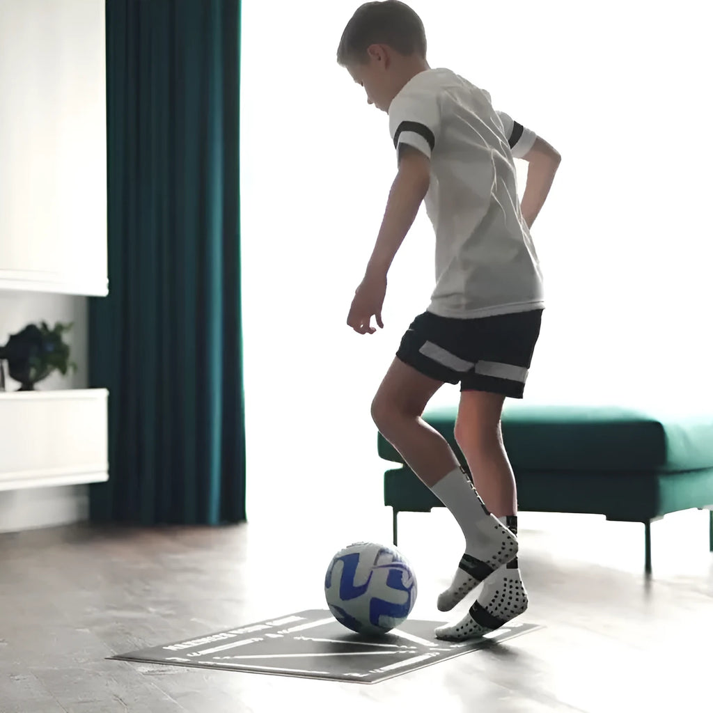 Black football training mat measuring 60cm by 90cm with non-slip surface for sports practice