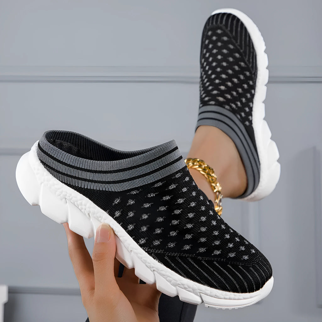 Women's black Flyknit socks semi slipper shoes with striped pattern and hollow-out design on a viscose sole.