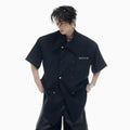 Men's loose fit short-sleeved casual shirt in black with spliced detailing and metal buttons