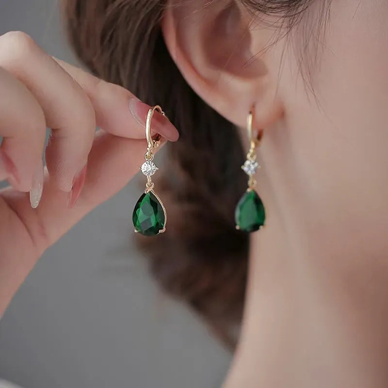 A pair of emerald green geometric teardrop earrings made from alloy.