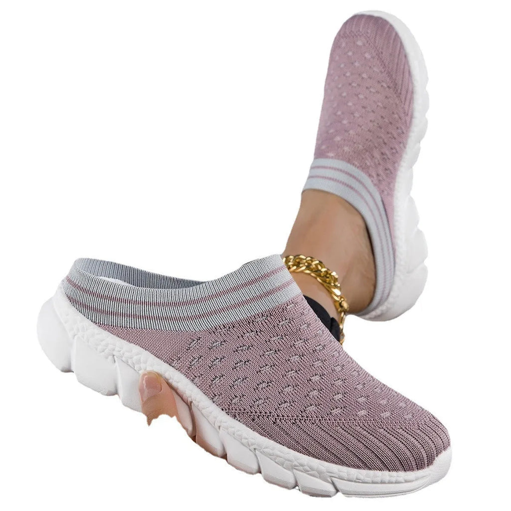 Women's black Flyknit socks semi slipper shoes with striped pattern and hollow-out design on a viscose sole.