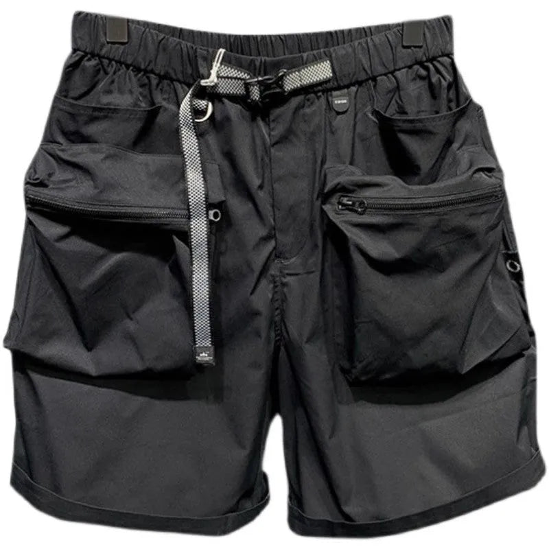 Men's loose fit black work shorts with pockets, shown on a model