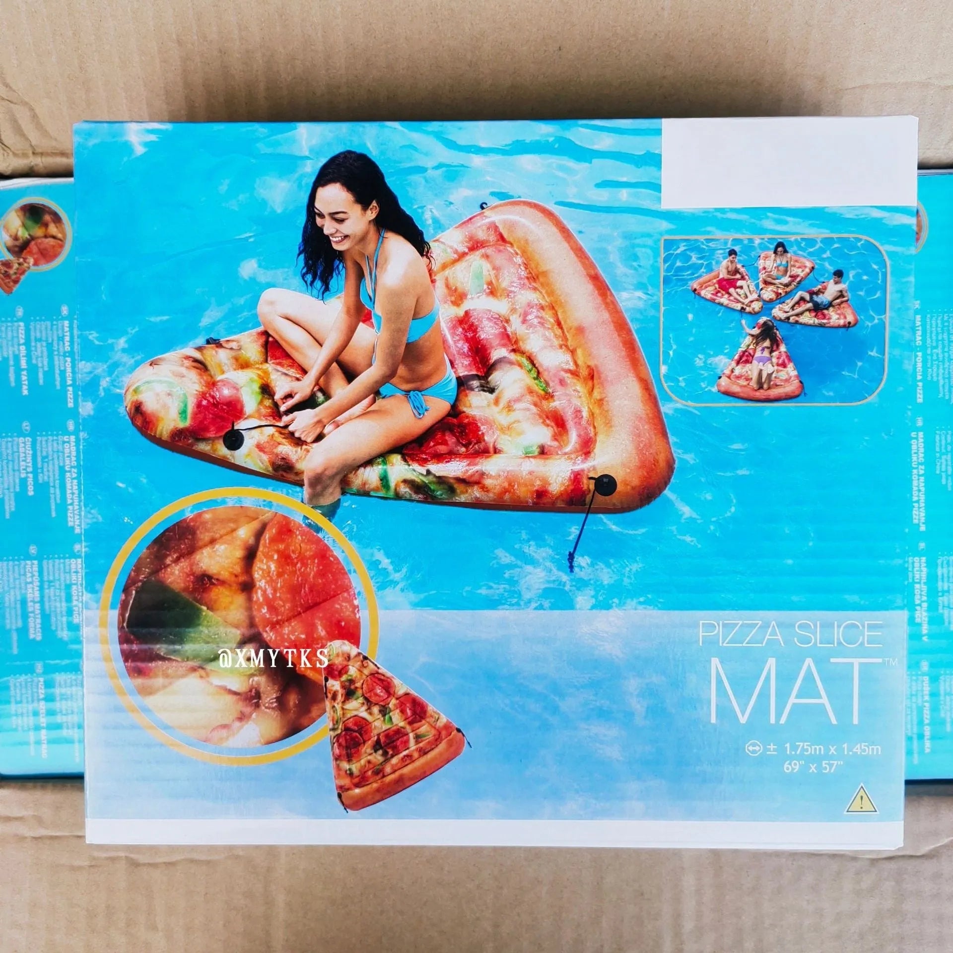 Large inflatable pizza surfboard recliner floating on water with bright multicolour design