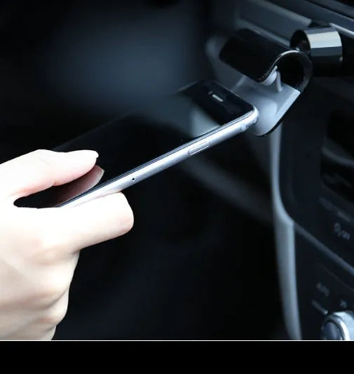 Black car phone holder with 360-degree rotating mechanism mounted on dashboard