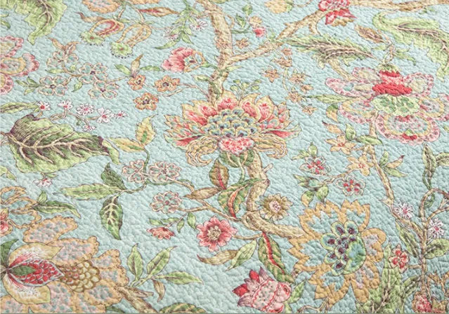 Blue cotton bedspread with floral and bird pattern, part of a 3-piece quilted bedding set.