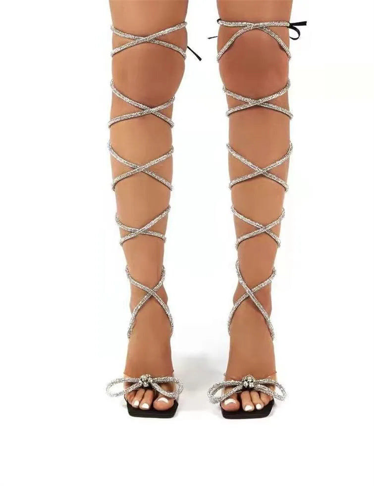 Plus size women's black strappy sandals with rhinestone straps and a square toe.