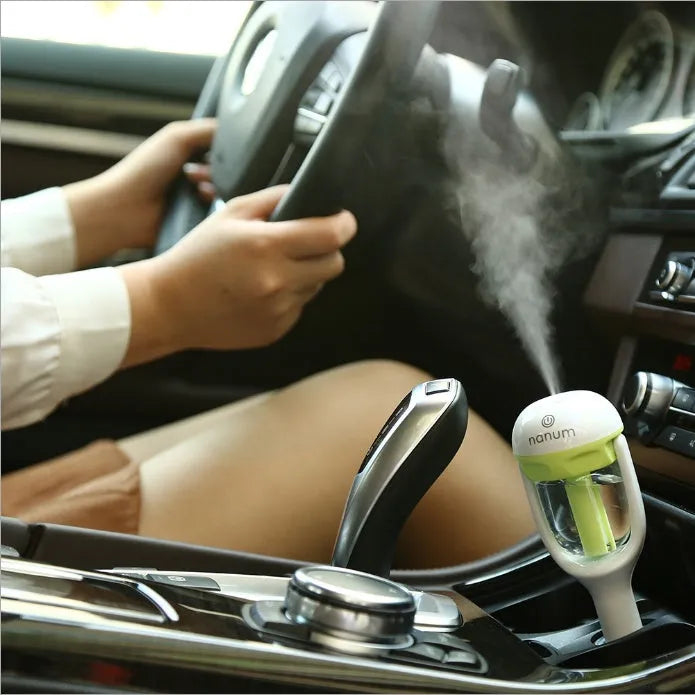 Blue portable car humidifier air purifier with 180 degree rotation on car dashboard