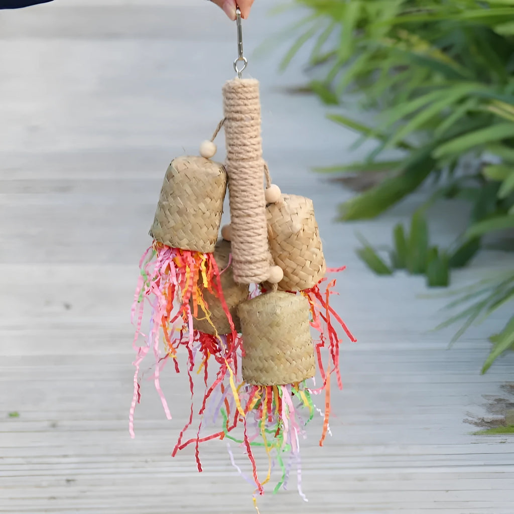 Wood and sisal parrot toy with colourful shredded paper measuring 15cm by 35cm