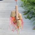 Wood and sisal parrot toy with colourful shredded paper measuring 15cm by 35cm