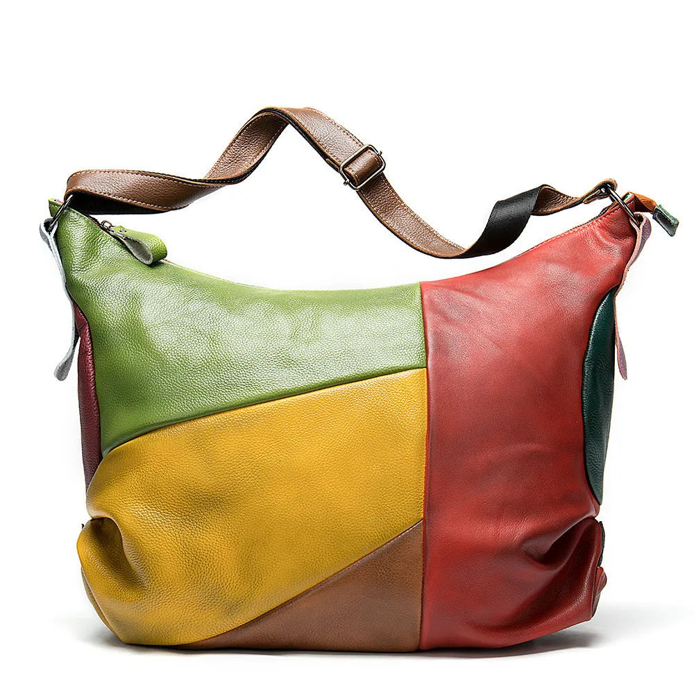 Brown cowhide leather travel bag with contrast stitching, shown as a crossbody bag.