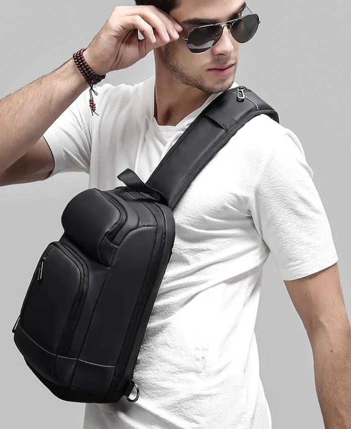 Black PVC outdoor shoulder bag with air cushion strap showing internal laptop and phone compartments