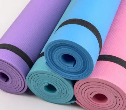 EVA fitness yoga mat in blue, showing its texture and thickness, rolled up with its OPP storage bag.