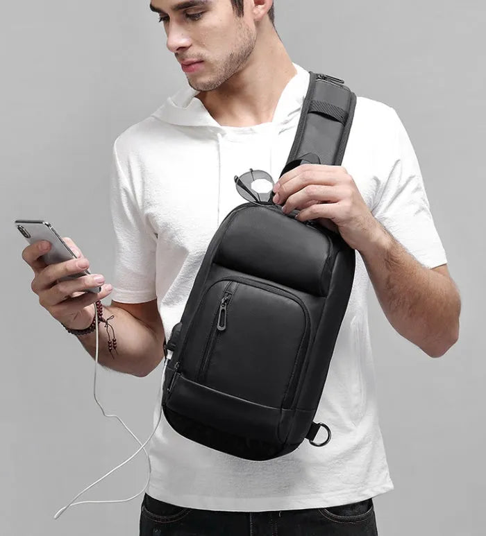 Black PVC outdoor shoulder bag with air cushion strap showing internal laptop and phone compartments