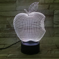 Colourful 3D fruit-shaped LED night light with touch control on a surface.