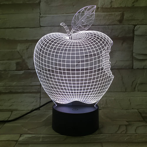 Colourful 3D fruit-shaped LED night light with touch control on a surface.