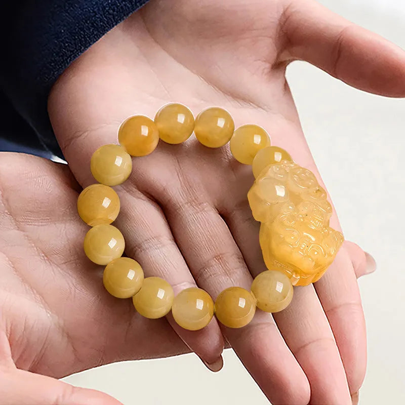 Golden Thread Jinsi Jade money bracelet with carved beads in two size options.