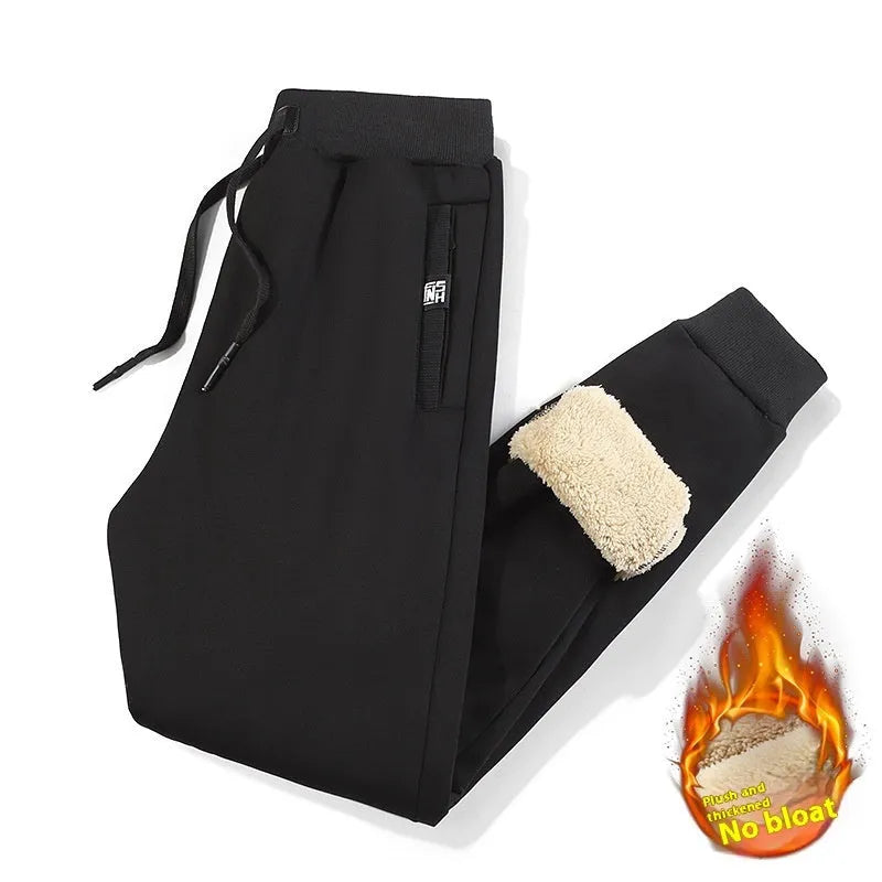 Men's grey fleece-lined cotton track pants in oversized style showing drawstring leg detail