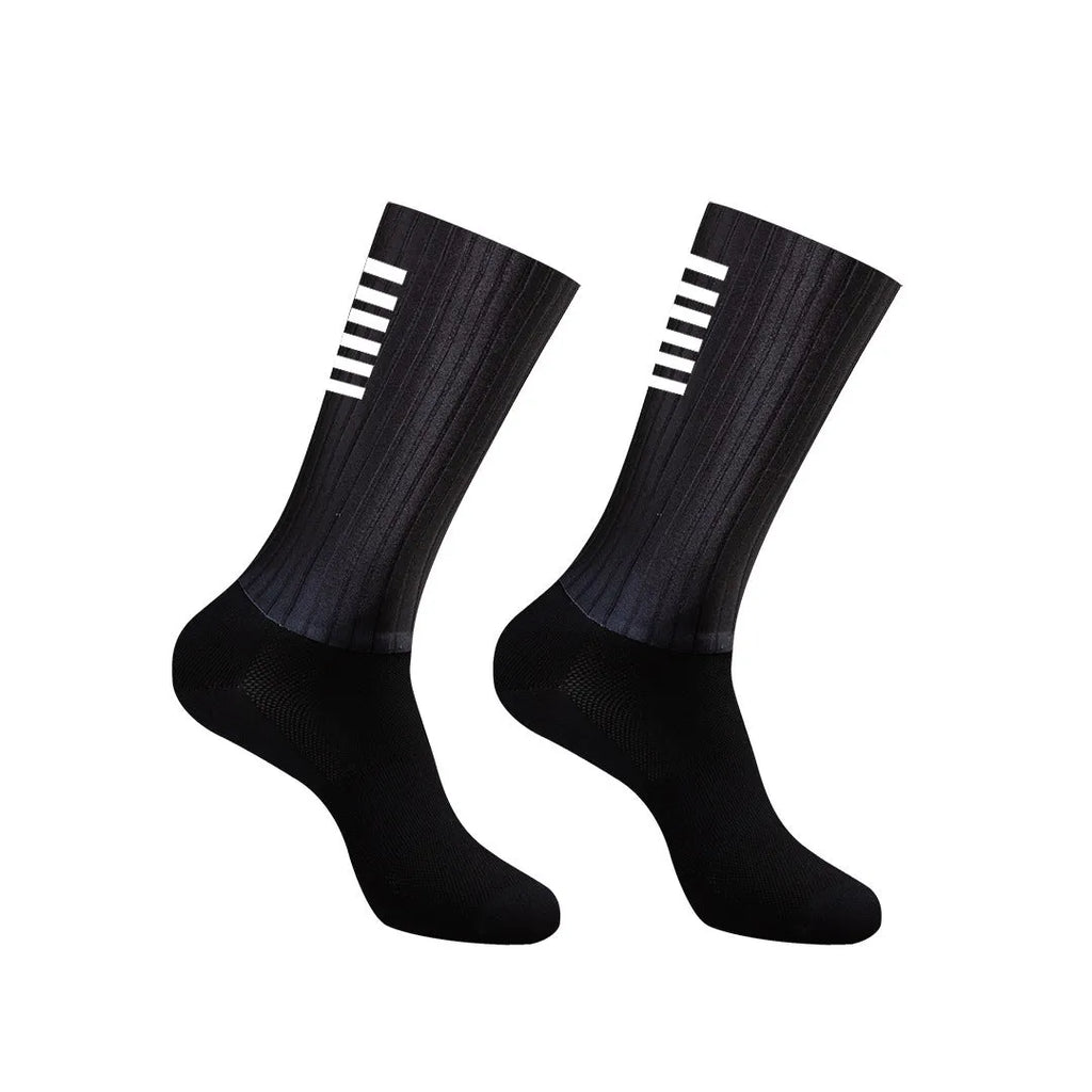 A pair of athletic cycling and running socks in a moisture-wicking fabric blend on a grey background.