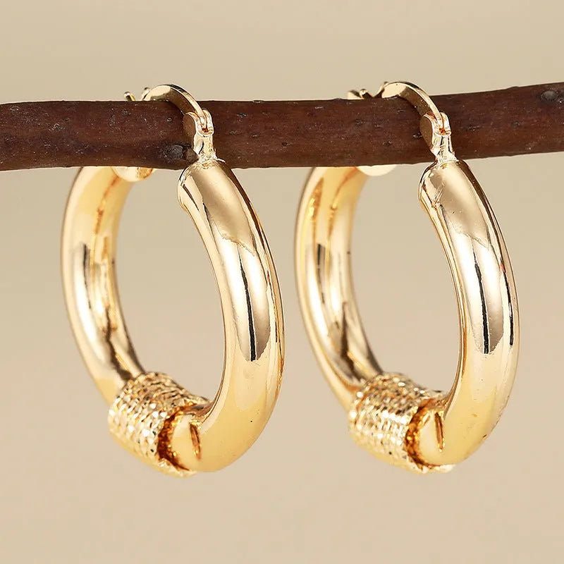 Geometric copper earrings with ring and line design in golden colour