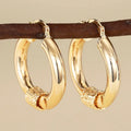 Geometric copper earrings with ring and line design in golden colour