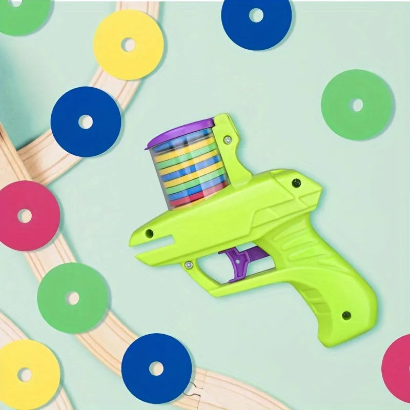 Green durable plastic battery-free cat toy launcher with a foam disc on a wooden floor.