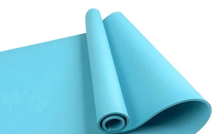 EVA fitness yoga mat in blue, showing its texture and thickness, rolled up with its OPP storage bag.