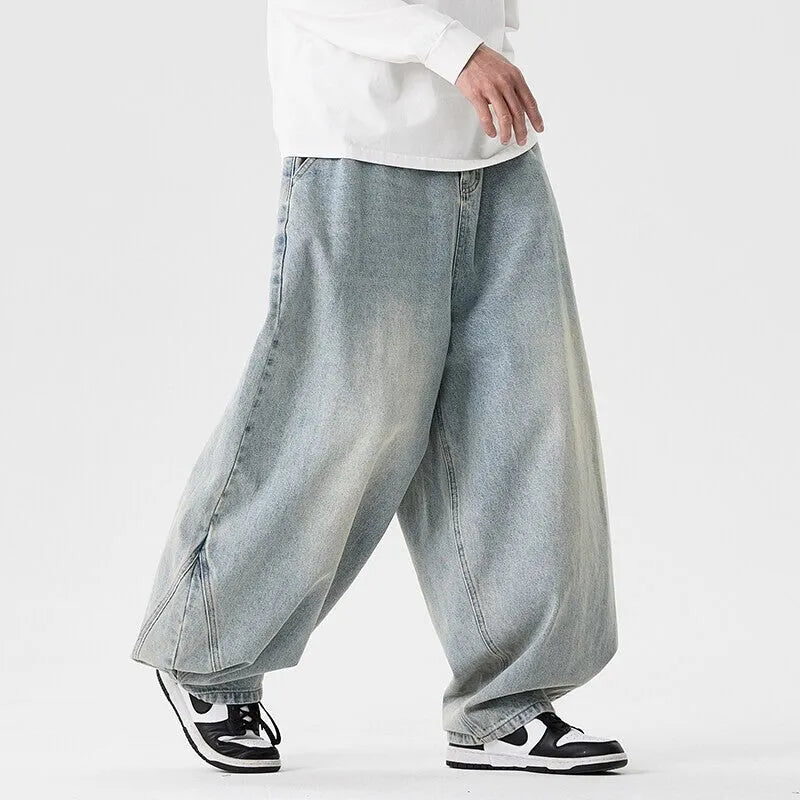 Men's plus size light blue wide leg baggy denim jeans with a low waist and straight leg opening.