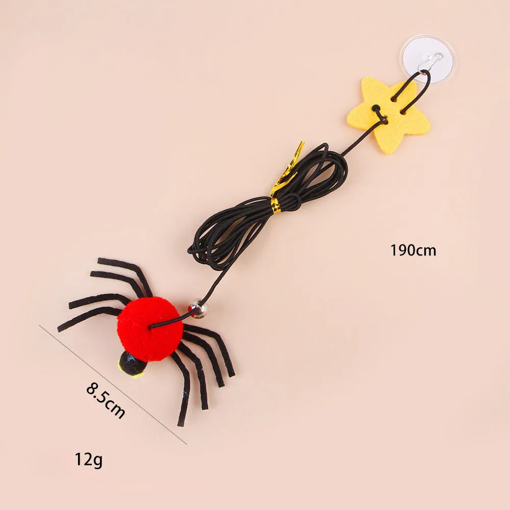 Red cat hanging door toy with elastic rope, feather, bell, and spider decoration